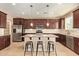 Spacious kitchen with stainless steel appliances, granite countertops, large island and bar stool seating at 2674 N Saide Ln, Buckeye, AZ 85396