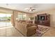 Bright living room with patio access, comfy seating, and stylish entertainment unit at 2674 N Saide Ln, Buckeye, AZ 85396