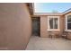 Charming front patio area with a welcoming entrance, cozy seating, and well-maintained stucco exterior at 2674 N Saide Ln, Buckeye, AZ 85396
