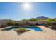 Inviting backyard pool with desert landscaping, mountain views, and relaxing seating area on a spacious patio at 2674 N Saide Ln, Buckeye, AZ 85396