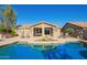 Beautiful backyard with a refreshing pool, inviting lounge chairs, and an outdoor dining area at 2674 N Saide Ln, Buckeye, AZ 85396