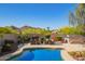 Gorgeous backyard pool with mountain views, relaxing seating, and well-manicured landscaping for ultimate outdoor enjoyment at 2674 N Saide Ln, Buckeye, AZ 85396