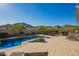 Private backyard featuring a sparkling pool, patio, and beautifully landscaped garden at 2674 N Saide Ln, Buckeye, AZ 85396