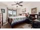 This cozy bedroom has a decorative quilt, ceiling fan, and a place for an office at 280 S Evergreen Rd # 1320, Tempe, AZ 85288