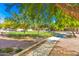 Landscaped community space in a townhouse complex with mature trees and walking paths at 280 S Evergreen Rd # 1320, Tempe, AZ 85288