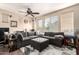 Spacious living room with a large sectional sofa, a ceiling fan, neutral paint and a large window at 280 S Evergreen Rd # 1320, Tempe, AZ 85288