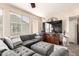 Comfortable living room with plush sectional, TV, and natural light from large window at 280 S Evergreen Rd # 1320, Tempe, AZ 85288
