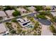 Aerial view of a luxury home with a solar panel roof, pool, and meticulously landscaped desert surroundings at 28019 N 115 Pl, Scottsdale, AZ 85262