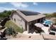 Outdoor living area with patio, pool, solar panels, desert landscaping, and barbecue at 28019 N 115 Pl, Scottsdale, AZ 85262