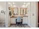 Dual sink bathroom vanity with granite countertops and a chair for comfort and convenience at 28019 N 115 Pl, Scottsdale, AZ 85262