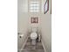 Small bathroom with a toilet and paper towels and decorative wall art, perfect for guests at 28019 N 115 Pl, Scottsdale, AZ 85262
