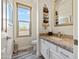 Bathroom featuring granite counters, white cabinets, decorative towels and a window overlooking a beautiful landscape at 28019 N 115 Pl, Scottsdale, AZ 85262