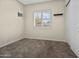 A bright bedroom featuring neutral walls, plush carpeting, and window bringing natural light to the space at 28019 N 115 Pl, Scottsdale, AZ 85262