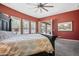 Spacious main bedroom with neutral and accent walls, stylish ceiling fan, and sliding glass door to the outdoors at 28019 N 115 Pl, Scottsdale, AZ 85262