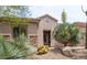 Inviting single-story home with stone accents and desert landscaping, creating a serene entrance at 28019 N 115 Pl, Scottsdale, AZ 85262