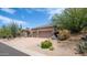 Spacious two-car garage with desert landscaping including a variety of cacti and other plants at 28019 N 115 Pl, Scottsdale, AZ 85262