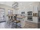 Well-lit kitchen features white cabinets, granite countertops, and stainless steel appliances at 28019 N 115 Pl, Scottsdale, AZ 85262
