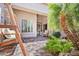 Serene covered patio with swing, lush greenery, and a tranquil water feature, perfect for relaxation at 28019 N 115 Pl, Scottsdale, AZ 85262