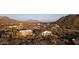Aerial view of two homes in a desert landscape, with mountains in the distance at 2918 N 90Th St, Mesa, AZ 85207