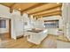 Bright kitchen with a center island, wood beams, and white cabinets, perfect for culinary enthusiasts at 2918 N 90Th St, Mesa, AZ 85207