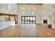 Spacious living room with wood floors, large windows, and modern fireplace, providing an elegant space at 2918 N 90Th St, Mesa, AZ 85207