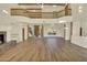 Open-concept living room with high ceilings, wood beams, and a grand staircase creating a welcoming atmosphere at 2918 N 90Th St, Mesa, AZ 85207
