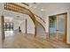 Bright, open living room with hardwood floors, a grand staircase, and elegant wood detailing at 2918 N 90Th St, Mesa, AZ 85207