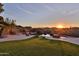 Stunning backyard pool with rock features and sunset view, perfect for outdoor relaxation and entertaining at 2918 N 90Th St, Mesa, AZ 85207