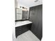 Modern bathroom features a sleek black vanity with white countertop and stylish lighting at 3371 W Grandview Rd, Phoenix, AZ 85053