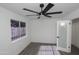 Bright bedroom featuring wood floors, a modern ceiling fan, and a window with bars at 3371 W Grandview Rd, Phoenix, AZ 85053