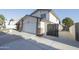 Exterior view of a two-story house featuring a two-car garage and metal gate at 3371 W Grandview Rd, Phoenix, AZ 85053