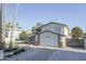 Exterior view of a two-story house featuring a two-car garage and metal gate at 3371 W Grandview Rd, Phoenix, AZ 85053