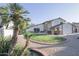 Home front yard featuring Palm trees, a circular flower bed, decorative rock and a two-story house at 3371 W Grandview Rd, Phoenix, AZ 85053