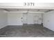 A well-organized garage with ample storage cabinets and a clean, finished floor at 3371 W Grandview Rd, Phoenix, AZ 85053