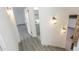Hallway with modern lighting fixtures, a bathroom view, and new vinyl floors on stairs at 3371 W Grandview Rd, Phoenix, AZ 85053