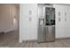 Bright kitchen with stainless steel refrigerator and white cabinets at 3371 W Grandview Rd, Phoenix, AZ 85053