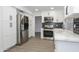 Renovated kitchen featuring white cabinets, stainless steel appliances and marble countertops at 3371 W Grandview Rd, Phoenix, AZ 85053