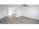 An open living room with vinyl floors, white walls, modern ceiling fan, and built-in storage at 3371 W Grandview Rd, Phoenix, AZ 85053