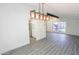 Bright living room featuring hardwood floors, modern lighting, and updated kitchen view at 3371 W Grandview Rd, Phoenix, AZ 85053