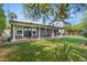 View of the backyard including the covered patio and grassy area at 3411 E Sells Dr, Phoenix, AZ 85018