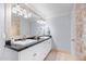 Bathroom features double sinks, granite counters, tiled floors, and modern lighting at 3411 E Sells Dr, Phoenix, AZ 85018
