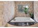 Bathroom features jacuzzi tub with a black granite surround and tiled walls at 3411 E Sells Dr, Phoenix, AZ 85018