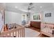 This Bedroom has two cribs, a changing table, and a closet for lots of storage at 3411 E Sells Dr, Phoenix, AZ 85018