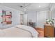 This bedroom features a ceiling fan, an area for a desk, and a closet for storage at 3411 E Sells Dr, Phoenix, AZ 85018