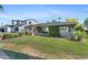 Charming single-story home with mature trees and a luscious green front lawn at 3411 E Sells Dr, Phoenix, AZ 85018