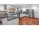 Bright kitchen features stainless steel appliances, white cabinets, and wood floors at 3411 E Sells Dr, Phoenix, AZ 85018