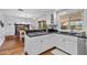 This kitchen features stainless steel appliances, white cabinets, granite counters and wood floors at 3411 E Sells Dr, Phoenix, AZ 85018
