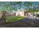 Grassy backyard offering a patio area, mature trees, and ample space for outdoor activities at 35616 N 34Th Ln, Phoenix, AZ 85086