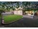 Private backyard with a lush lawn, paved patio, desert landscaping, and mature shade trees at 35616 N 34Th Ln, Phoenix, AZ 85086