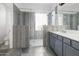 Bathroom featuring a glass shower, double vanity, modern finishes, and tile floors at 35616 N 34Th Ln, Phoenix, AZ 85086